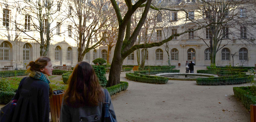 Image of students standing in a campus courtyard.